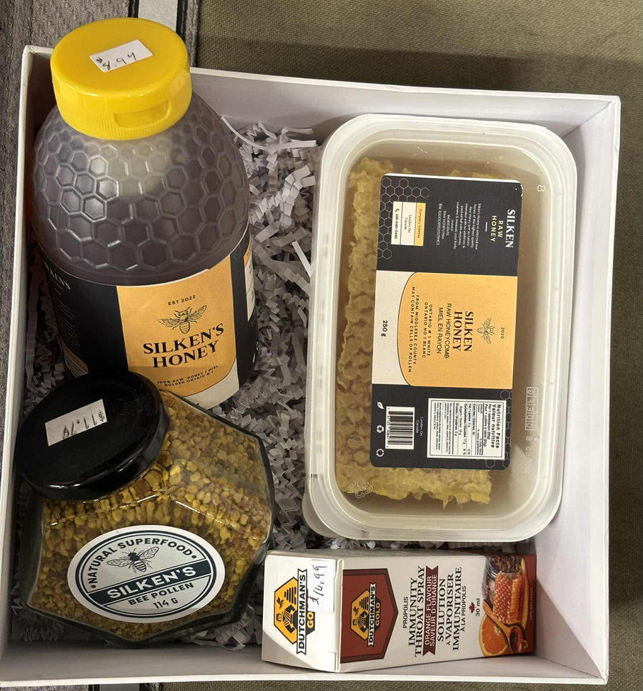 Bee Mine Wellness Box with raw honey, honeycomb, bee propolis spray, and bee pollen in gift-ready packaging